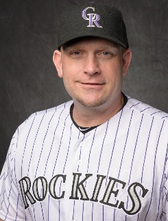 A baseball player wearing a black hat Description automatically generated